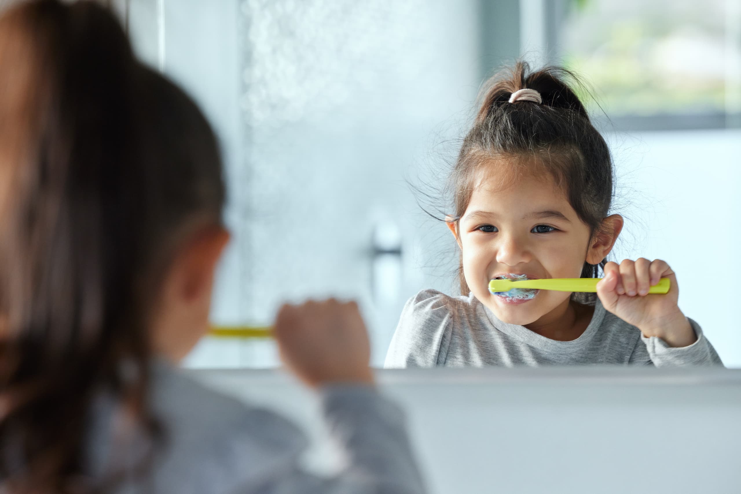 girl brushing her teeth