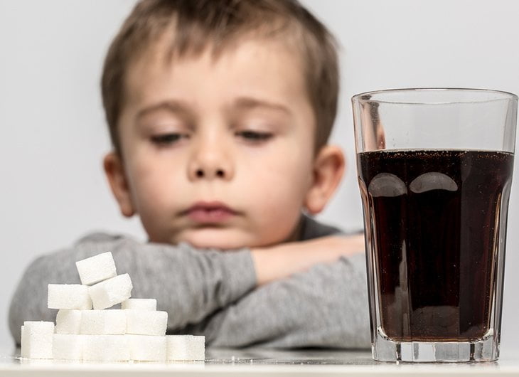 child with sugary drink