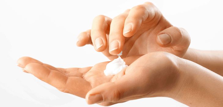 female hands with face cream