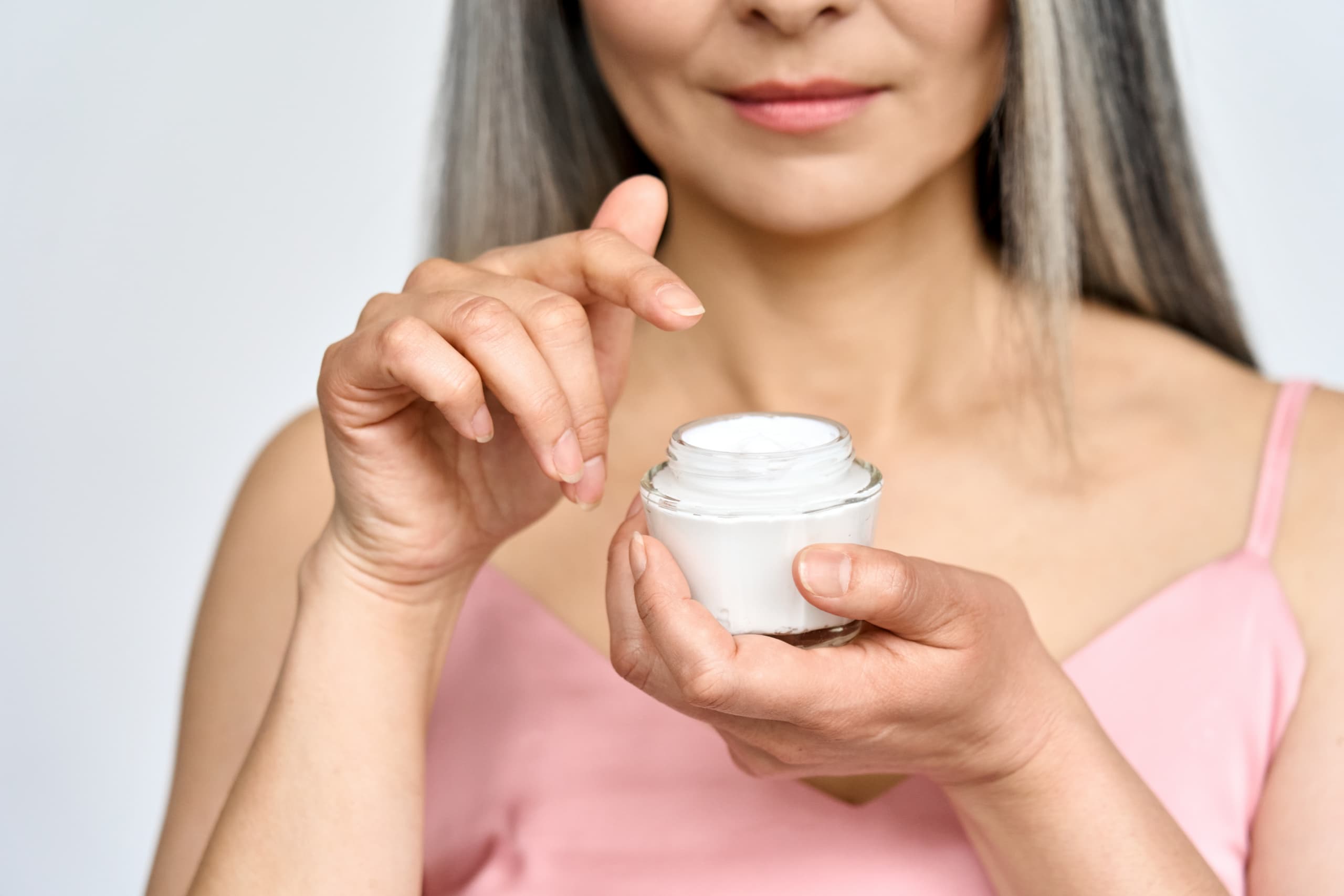 Woman applying skincare