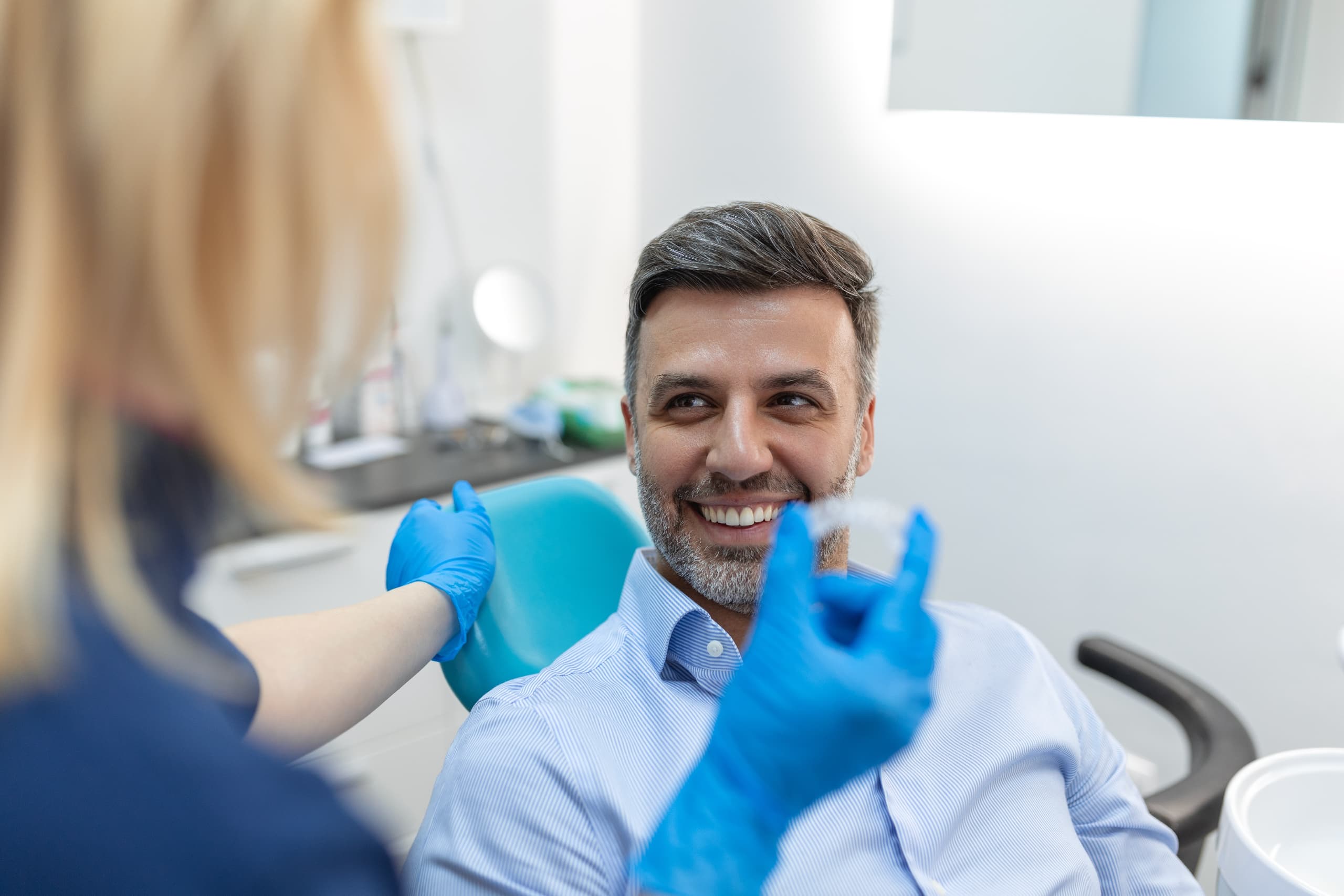 dentist showing patient invisible braces