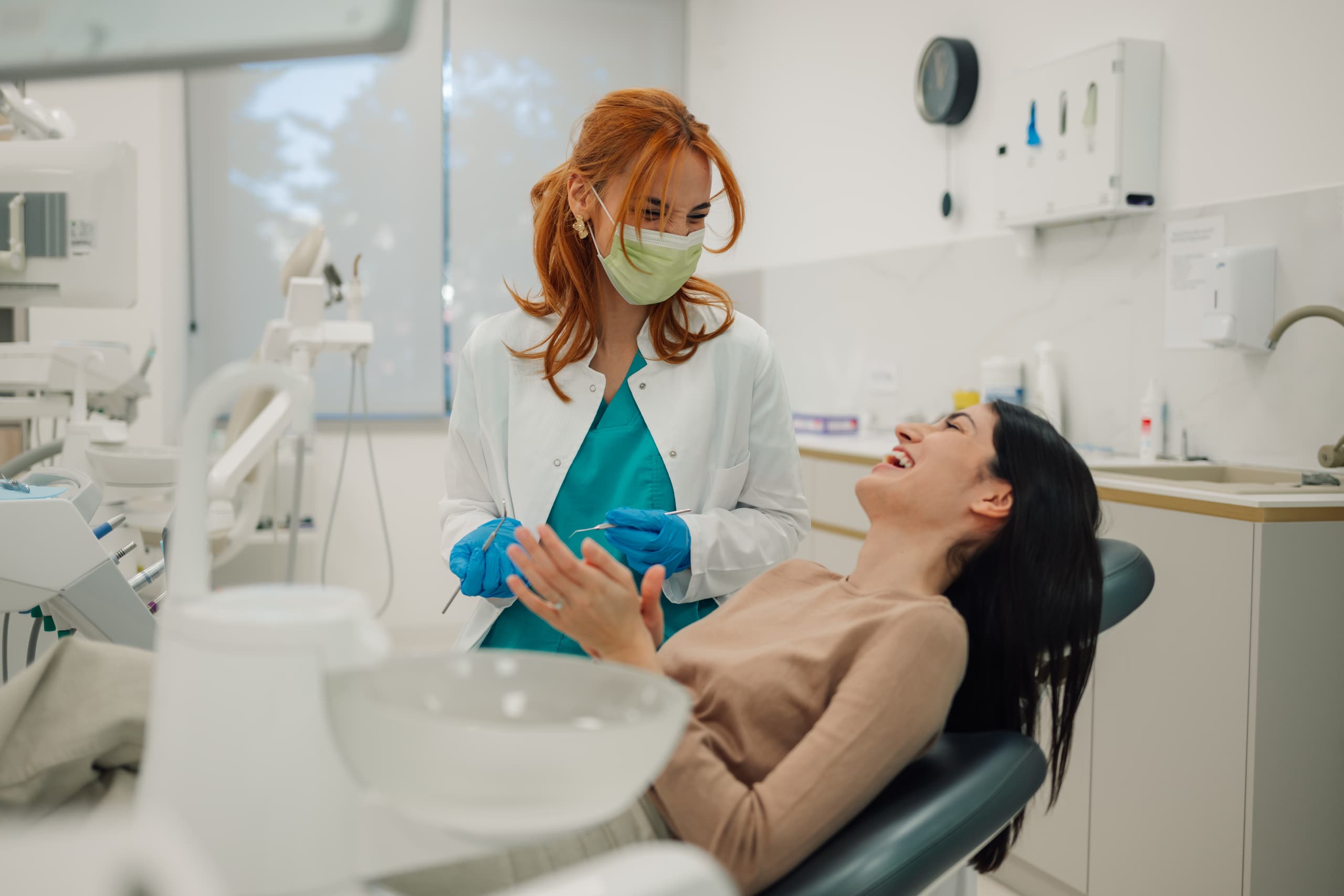 dentist and happy patient talking